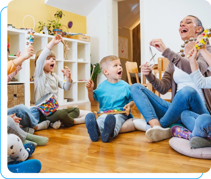 A group of people sitting on the floor playing wii