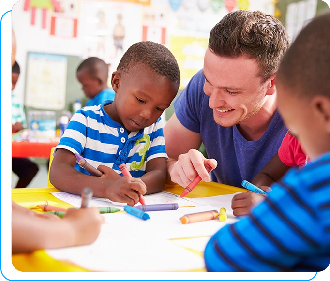 A man and two boys are drawing with markers.