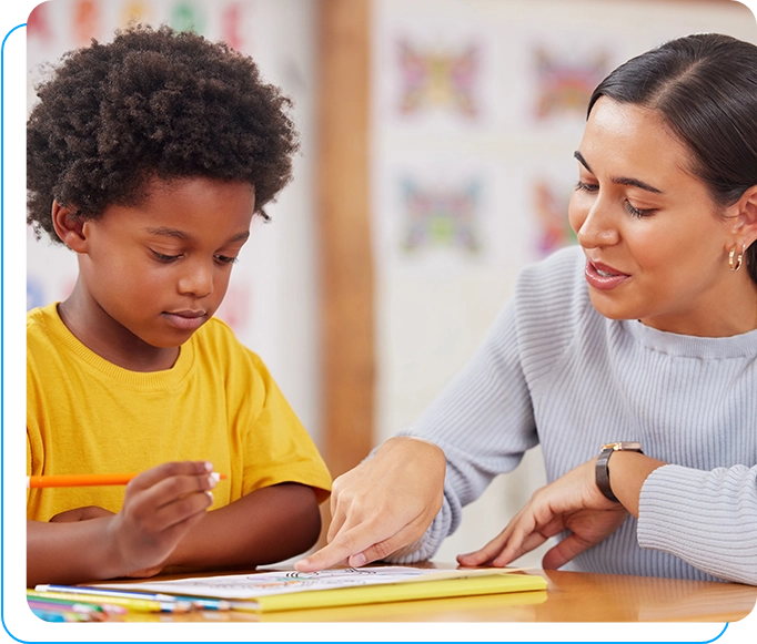 A woman helping a child with an activity.